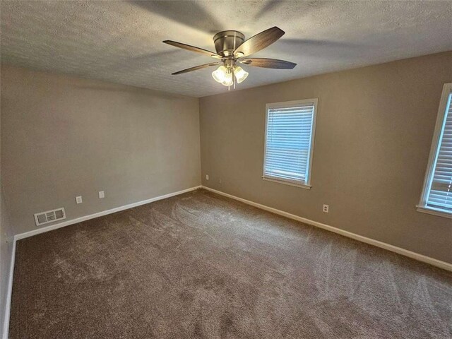 spare room with carpet, a textured ceiling, and ceiling fan