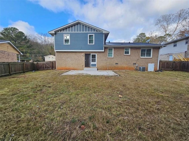 back of property with a yard, cooling unit, and a patio area