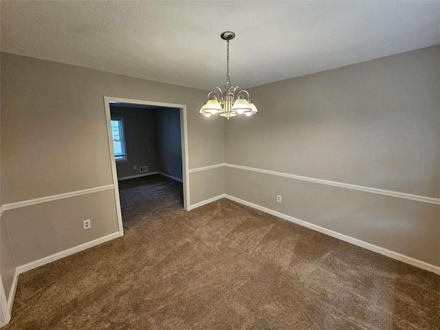 unfurnished dining area featuring a notable chandelier and dark carpet