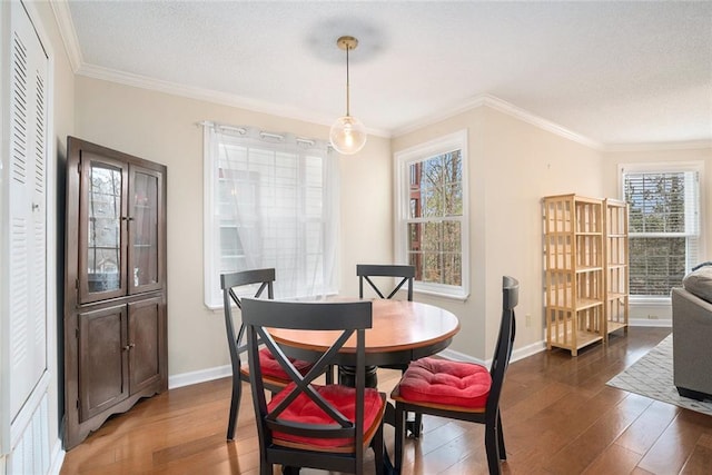 dining room with ornamental molding and dark hardwood / wood-style floors