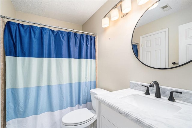 bathroom with vanity, toilet, a textured ceiling, and a shower with shower curtain