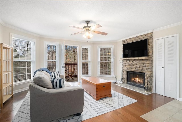 living room featuring ornamental molding, dark hardwood / wood-style flooring, and a textured ceiling