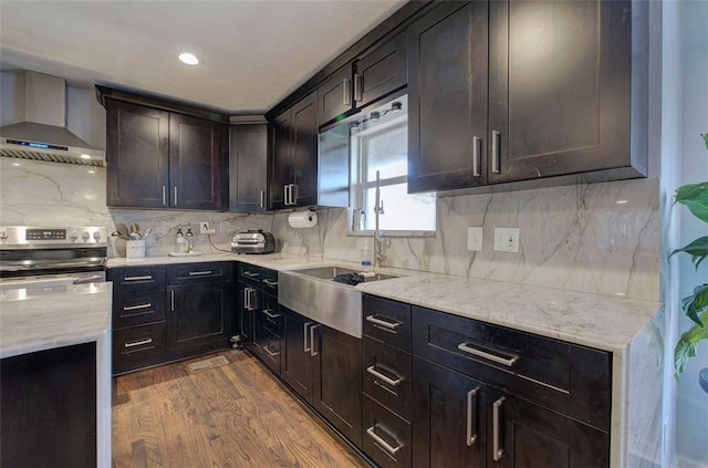 kitchen featuring stainless steel electric range oven, wall chimney range hood, dark wood-style flooring, and backsplash