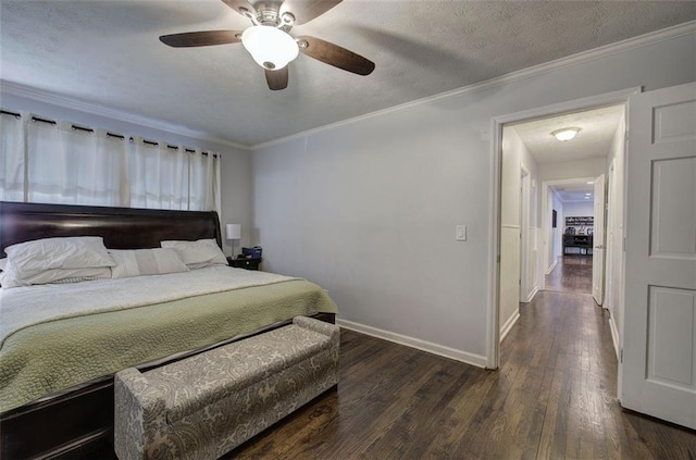 bedroom with ornamental molding, a textured ceiling, baseboards, and wood finished floors