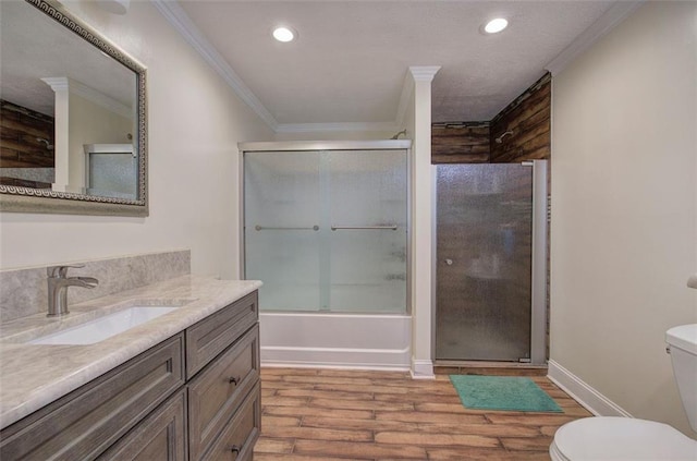 full bath featuring bath / shower combo with glass door, toilet, ornamental molding, wood finished floors, and vanity