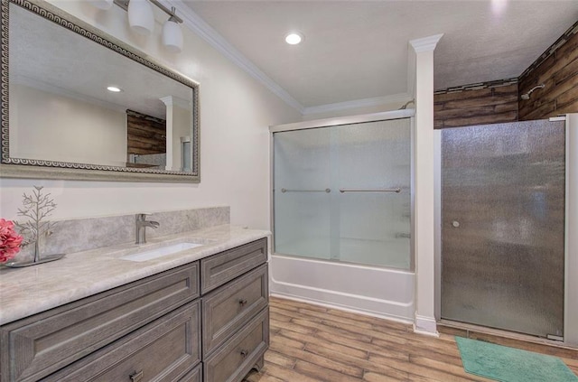 full bathroom with enclosed tub / shower combo, recessed lighting, wood finished floors, vanity, and ornamental molding