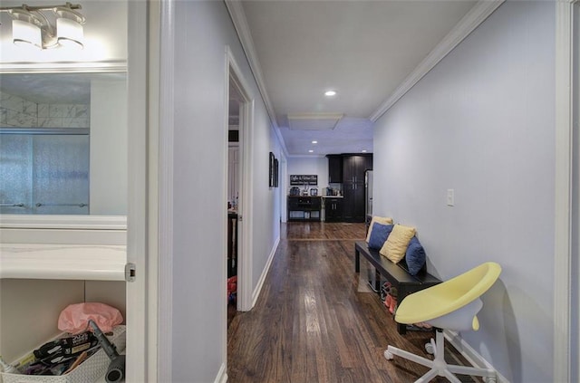 corridor with attic access, baseboards, dark wood-style floors, crown molding, and recessed lighting