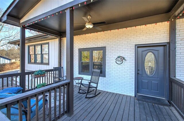 view of exterior entry featuring ceiling fan