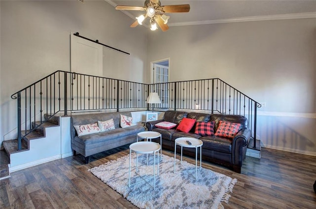 living room with crown molding, stairs, baseboards, and dark wood-style flooring