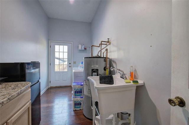 interior space featuring dark wood-type flooring, a sink, and electric water heater