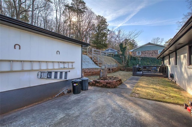 view of property exterior featuring a wooden deck