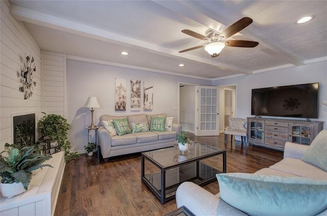 living area with a fireplace, dark wood finished floors, beamed ceiling, and recessed lighting