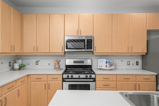 1344 Fernwood Cir NE, Brookhaven, GA 30319 - kitchen featuring stainless steel appliances, light countertops, and light brown cabinets