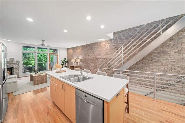 1344 Fernwood Cir NE, Brookhaven, GA 30319 - kitchen with dishwasher, light wood-type flooring, open floor plan, a ceiling fan, and a stone fireplace