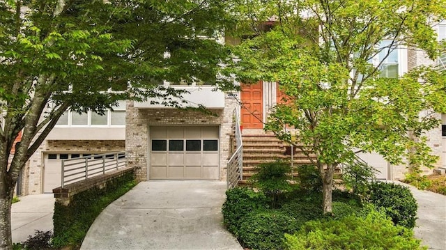 1344 Fernwood Cir NE, Brookhaven, GA 30319 - view of front of home with concrete driveway, brick siding, and a garage