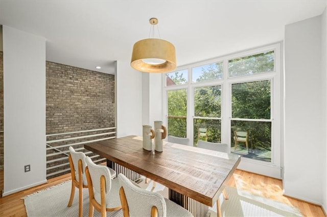 1344 Fernwood Cir NE, Brookhaven, GA 30319 - dining space featuring brick wall and light wood-style floors