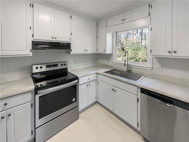 kitchen with a sink, under cabinet range hood, stainless steel appliances, and light countertops