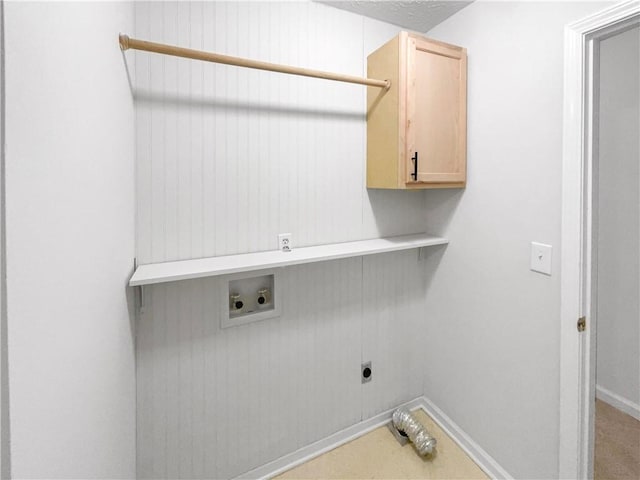 laundry area featuring hookup for a washing machine, cabinet space, hookup for an electric dryer, and baseboards