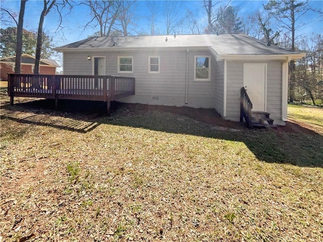 rear view of property featuring entry steps, crawl space, a lawn, and a deck