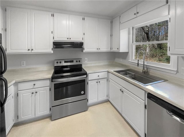 kitchen with a sink, stainless steel appliances, and light countertops