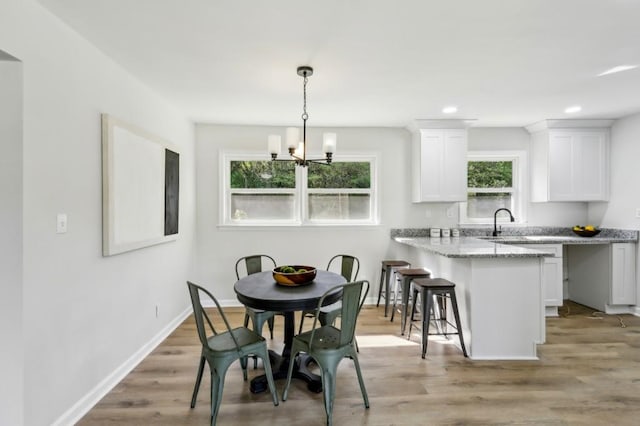 2519 Miriam Ln, Decatur, GA 30032 - dining space featuring baseboards, recessed lighting, an inviting chandelier, and light wood-style floors