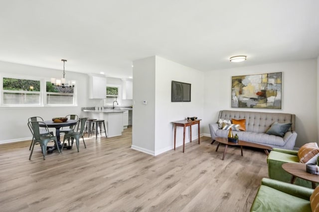 2519 Miriam Ln, Decatur, GA 30032 - living area featuring light wood finished floors, baseboards, and a chandelier