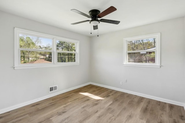 2519 Miriam Ln, Decatur, GA 30032 - spare room featuring baseboards, visible vents, wood finished floors, and ceiling fan