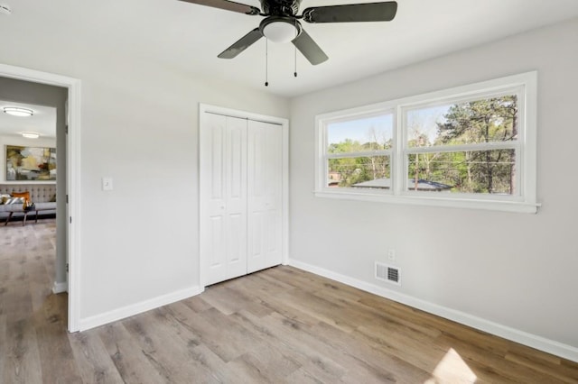 2519 Miriam Ln, Decatur, GA 30032 - unfurnished bedroom featuring baseboards, visible vents, a closet, and wood finished floors