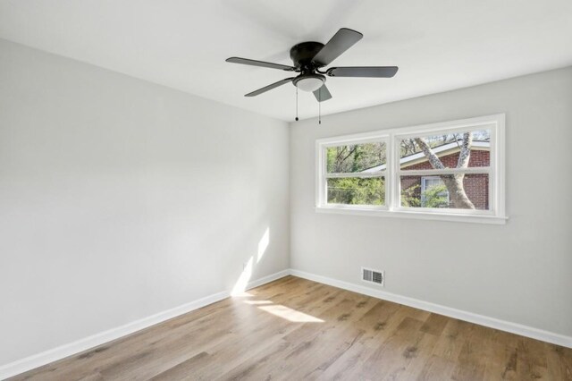2519 Miriam Ln, Decatur, GA 30032 - empty room featuring a ceiling fan, wood finished floors, baseboards, and visible vents