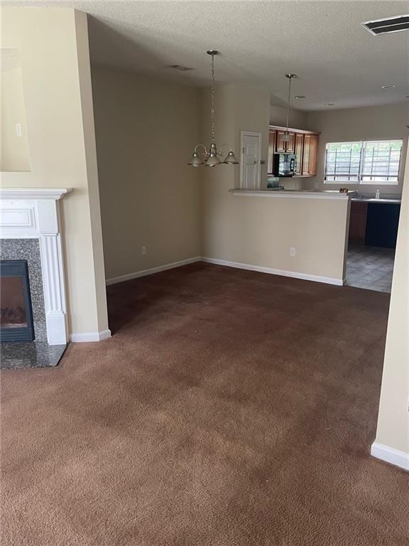 8170 Oakley Cir, Union City, GA 30291 - unfurnished living room featuring dark carpet, a textured ceiling, and a tiled fireplace