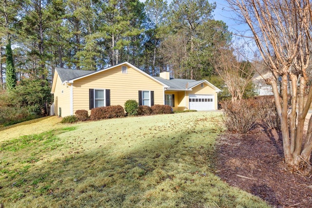 ranch-style home with a garage and a front lawn