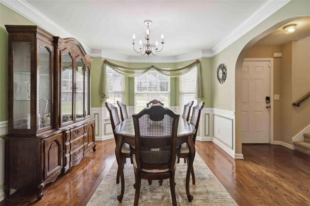 1127 Oak Hollow Ct, Hampton, GA 30228 - dining area with arched walkways, a chandelier, stairs, wood finished floors, and wainscoting