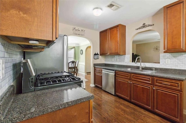 1127 Oak Hollow Ct, Hampton, GA 30228 - kitchen with appliances with stainless steel finishes, arched walkways, and dark countertops