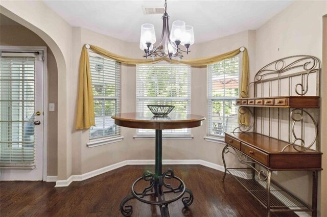 1127 Oak Hollow Ct, Hampton, GA 30228 - dining space featuring a chandelier, plenty of natural light, wood finished floors, and baseboards