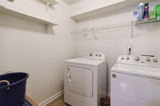 1127 Oak Hollow Ct, Hampton, GA 30228 - washroom featuring washing machine and dryer, baseboards, and tile patterned flooring