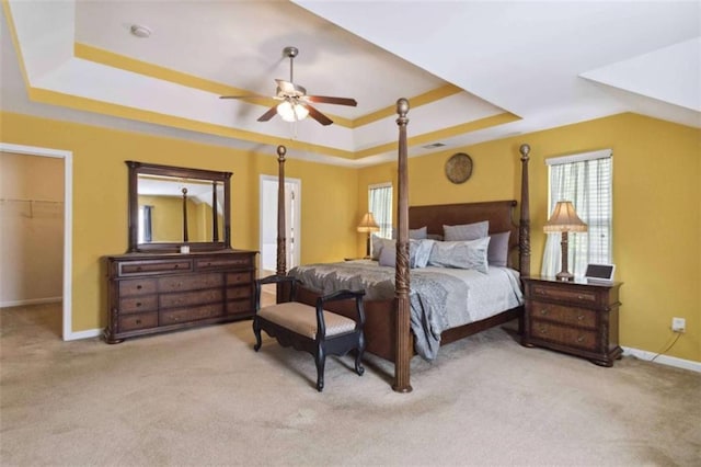1127 Oak Hollow Ct, Hampton, GA 30228 - bedroom featuring a tray ceiling, carpet floors, baseboards, a spacious closet, and a ceiling fan
