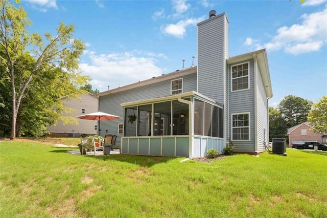 1127 Oak Hollow Ct, Hampton, GA 30228 - back of property featuring a sunroom, a chimney, cooling unit, and a lawn