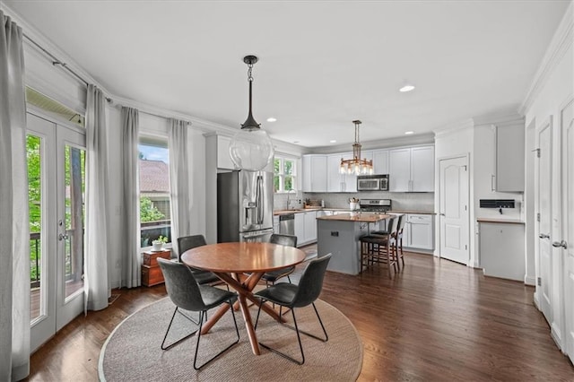 1622 Gates Pl NW, Atlanta, GA 30318 - dining room with ornamental molding, recessed lighting, dark wood-style floors, and a chandelier