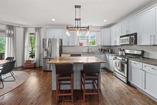 1622 Gates Pl NW, Atlanta, GA 30318 - kitchen featuring appliances with stainless steel finishes, plenty of natural light, a center island, backsplash, and recessed lighting