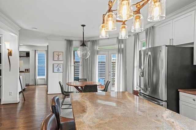 1622 Gates Pl NW, Atlanta, GA 30318 - dining space with dark wood-style floors, ornamental molding, and a chandelier