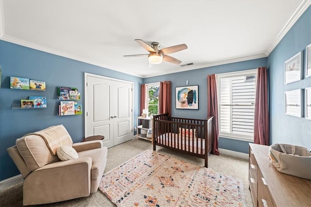 1622 Gates Pl NW, Atlanta, GA 30318 - bedroom with ornamental molding, light colored carpet, a closet, a ceiling fan, and a crib