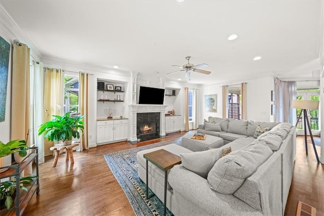 1622 Gates Pl NW, Atlanta, GA 30318 - living area featuring healthy amount of natural light, crown molding, a ceiling fan, a warm lit fireplace, and recessed lighting