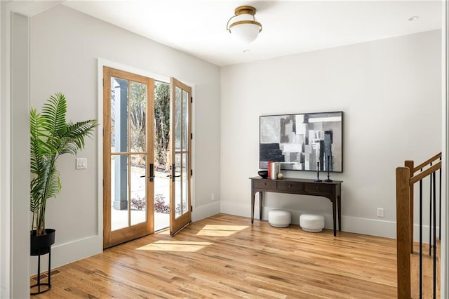 doorway to outside featuring french doors and light wood-type flooring