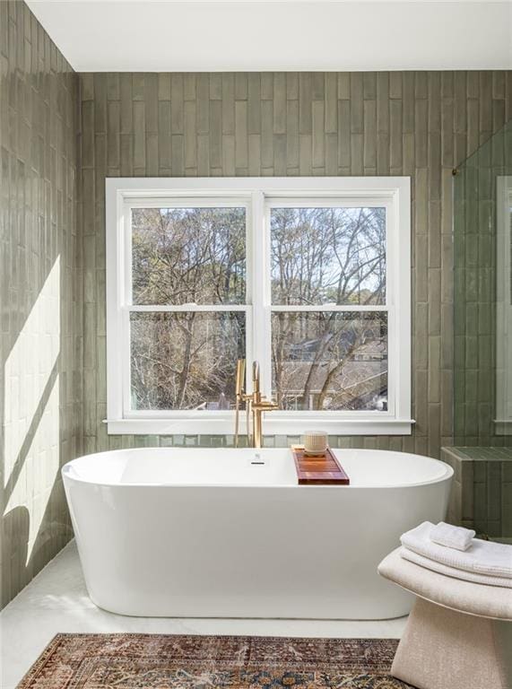 bathroom with tile walls and a washtub