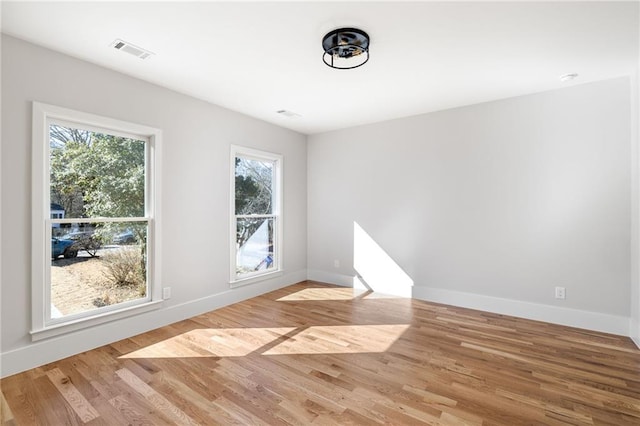 spare room with hardwood / wood-style flooring