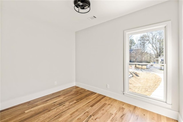 unfurnished room featuring hardwood / wood-style flooring