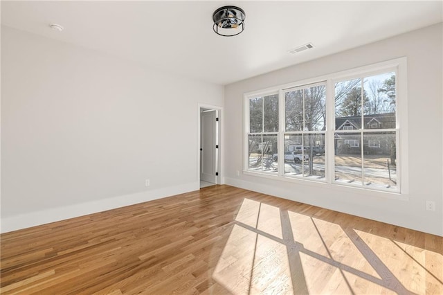 unfurnished room with hardwood / wood-style flooring