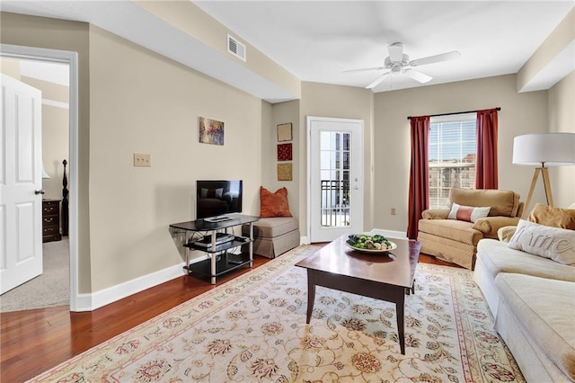 living room with hardwood / wood-style flooring and ceiling fan