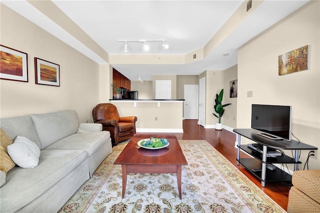 living room with hardwood / wood-style floors and rail lighting