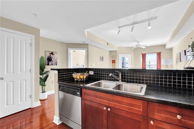 kitchen with hardwood / wood-style flooring, tasteful backsplash, stainless steel dishwasher, ceiling fan, and sink